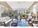 Inviting screened-in porch with ceiling fan and wicker furniture for outdoor relaxation at 119 Oakbluff Rd, Summerville, SC 29485