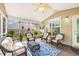 Comfortable porch features wicker furniture, ceiling fan, and blue patterned rug at 119 Oakbluff Rd, Summerville, SC 29485