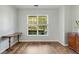 Room with a large window and wood-look flooring, featuring a wooden desk and dresser at 119 Oakbluff Rd, Summerville, SC 29485