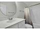 Clean bathroom with a shower and tub combination featuring a white vanity and neutral paint at 12 Leeann Ln, Mount Pleasant, SC 29464