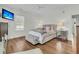 Bright, spacious bedroom with hardwood floors, decorative pillows, a ceiling fan, and large windows at 12 Leeann Ln, Mount Pleasant, SC 29464