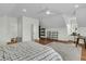 Large bedroom with vaulted ceilings offers hardwood floors, a sitting desk, and an ensuite bathroom at 12 Leeann Ln, Mount Pleasant, SC 29464