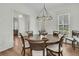 Elegant dining room with a round table, chandelier, and natural light from the windows at 12 Leeann Ln, Mount Pleasant, SC 29464