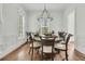 Bright dining room featuring a large round table, stylish chandelier, and hardwood floors at 12 Leeann Ln, Mount Pleasant, SC 29464