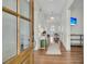 Bright foyer featuring hardwood floors, chandelier lighting, and a glimpse into the living spaces at 12 Leeann Ln, Mount Pleasant, SC 29464