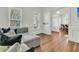 Inviting living room featuring a comfortable sectional couch, large windows, and hardwood floors at 12 Leeann Ln, Mount Pleasant, SC 29464