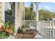 Cozy front porch featuring rocking chairs, a wood floor, plants, and white railings at 12 Leeann Ln, Mount Pleasant, SC 29464
