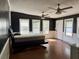 Spacious bedroom featuring dark walls, two ceiling fans, and multiple windows at 130 Oak Crest Dr, Moncks Corner, SC 29461
