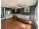 Open bedroom with dark walls, two fans, and natural light coming through the windows at 130 Oak Crest Dr, Moncks Corner, SC 29461