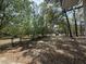 Long gravel driveway leading to a residence surrounded by mature trees on a sunny day at 130 Oak Crest Dr, Moncks Corner, SC 29461