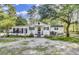 Charming white home with black shutters and a cozy front porch at 130 Oak Crest Dr, Moncks Corner, SC 29461