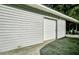 Side view of a spacious garage with a roll-up door and concrete driveway at 130 Oak Crest Dr, Moncks Corner, SC 29461
