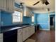 A light-filled kitchen with white cabinets, dark counters, and blue painted walls at 130 Oak Crest Dr, Moncks Corner, SC 29461
