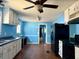 A well-lit kitchen with a fan, white cabinets, blue walls, and modern appliances at 130 Oak Crest Dr, Moncks Corner, SC 29461