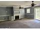 View of a living room featuring a traditional fireplace and ceiling fans at 130 Oak Crest Dr, Moncks Corner, SC 29461