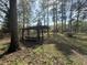 Outdoor pergola with bench seating surrounded by mature trees offering a serene and inviting space at 130 Oak Crest Dr, Moncks Corner, SC 29461