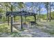 Wooden pergola with a swing bench, a bbq and a comfortable seating area at 130 Oak Crest Dr, Moncks Corner, SC 29461