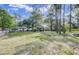 Expansive fenced yard showcasing a charming home and spacious grounds at 130 Oak Crest Dr, Moncks Corner, SC 29461