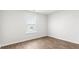 Well-lit bedroom features durable laminate flooring and a large window providing ample natural light at 131 River Hill Rd, Goose Creek, SC 29445