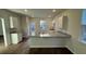 Bright kitchen featuring granite countertops, white cabinets, stainless steel sink, and modern lighting fixtures at 131 River Hill Rd, Goose Creek, SC 29445