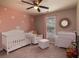 This charming Bedroom boasts a white crib, comfy armchair, and delightful daisy-themed decor at 1400 Harbor Mist Ct, Charleston, SC 29492