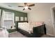 Cozy bedroom featuring a full bed, nature-themed art, and serene green accent wall at 1400 Harbor Mist Ct, Charleston, SC 29492