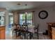 Dining room area with table set, natural light, wood floors, and a view to the living room at 1400 Harbor Mist Ct, Charleston, SC 29492