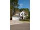 Charming two-story home with a well-maintained lawn, two car garage, and inviting red front door at 1400 Harbor Mist Ct, Charleston, SC 29492