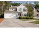 Charming two-story home with a well-maintained lawn, two car garage, and inviting red front door at 1400 Harbor Mist Ct, Charleston, SC 29492