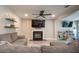 Cozy living room with a fireplace, mounted TV, ceiling fan, and a comfortable sectional sofa at 1400 Harbor Mist Ct, Charleston, SC 29492