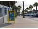 Street view featuring parked cars and palm trees along a sidewalk with nearby businesses and attractions at 1416 Dahlia Dr, Mount Pleasant, SC 29464