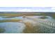 Panoramic aerial view of pier extending into marshland under a cloudy sky at 1479 Mossy Branch Way, Mount Pleasant, SC 29464