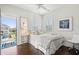 Bright bedroom with ceiling fan, access to balcony, and beach themed decor at 1479 Mossy Branch Way, Mount Pleasant, SC 29464
