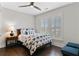 Bright bedroom featuring a ceiling fan, hardwood floors, and large window with plantation shutters at 1479 Mossy Branch Way, Mount Pleasant, SC 29464