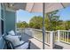 Outdoor deck with comfortable chairs overlooking a lush backyard and inviting pool area at 1479 Mossy Branch Way, Mount Pleasant, SC 29464