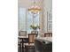 Dining area with a stylish chandelier, neutral decor, and plantation shutters for brightness and privacy at 1479 Mossy Branch Way, Mount Pleasant, SC 29464