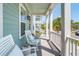 Inviting front porch featuring rocking chairs, stylish accents, and classic architectural details at 1479 Mossy Branch Way, Mount Pleasant, SC 29464