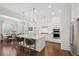 Well-lit kitchen featuring white cabinets, granite countertops, stainless steel appliances, and an island with seating at 1479 Mossy Branch Way, Mount Pleasant, SC 29464
