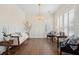 Bright living room with hardwood floors, elegant chandelier, and plantation shutters for ample natural light at 1479 Mossy Branch Way, Mount Pleasant, SC 29464