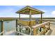 Close up of a pier gazebo with seats extending over the water on a sunny day at 1479 Mossy Branch Way, Mount Pleasant, SC 29464