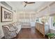 Bright sun room featuring a comfortable sectional sofa, neutral decor, and hardwood floors at 1479 Mossy Branch Way, Mount Pleasant, SC 29464