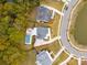 Overhead view of houses with pools, manicured lawns, and tree-lined streets surrounding a serene pond at 1529 Tomato Farm Cir, Mount Pleasant, SC 29464