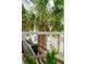 Outdoor living space with seating on a covered porch with white railings and a palm tree view at 1529 Tomato Farm Cir, Mount Pleasant, SC 29464