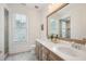 Elegant bathroom with dual sinks, wood vanity, and stylish mirror at 1529 Tomato Farm Cir, Mount Pleasant, SC 29464