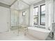 This bathroom features a glass shower, free-standing tub, and a bright window that lets in natural light at 1529 Tomato Farm Cir, Mount Pleasant, SC 29464