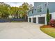 Large driveway with a three-car garage and partial basketball court at 1529 Tomato Farm Cir, Mount Pleasant, SC 29464