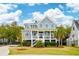 Beautifully designed two-story home with a classic front porch and well-manicured lawn at 1529 Tomato Farm Cir, Mount Pleasant, SC 29464