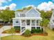 Charming two-story home featuring a welcoming front porch and beautifully landscaped front yard at 1529 Tomato Farm Cir, Mount Pleasant, SC 29464