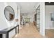 Bright foyer featuring a hardwood floor, elegant mirror, and seamless flow to the living area at 1529 Tomato Farm Cir, Mount Pleasant, SC 29464