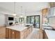 Spacious kitchen with island, stainless steel appliances, and sliding doors to outdoor area at 1529 Tomato Farm Cir, Mount Pleasant, SC 29464